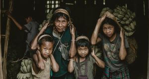 Children carrying heavy loads of bananas
